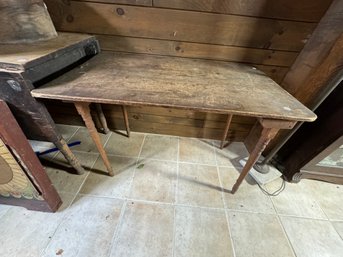 AN ANTIQUE FOLDING SEWING TABLE