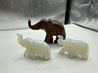 Two Irridesent White Elephants And One Wood Elephant