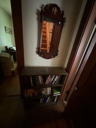 CHIPPENDALE MIRROR W/ EAGLE AND BOOKCASE FULL OF BOOKS