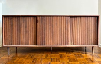 A Vintage Mid Century Modern Walnut Veneer Credenza With Tambour Doors And Iconic Stick Legs