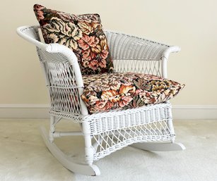 A Vintage Wicker Rocking Chair With Custom Tapestry Cushions