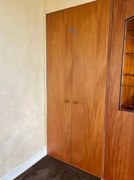 A Built - In Linen Closet With Doors - Primary