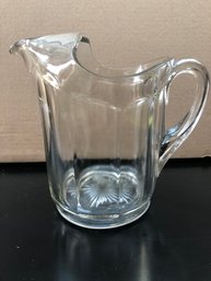Vintage Heavy Pressed Glass Pitcher With Ribbon Edge Design, Starburst Bottom And Curved Decorative Ice Lip.