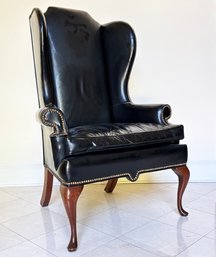 A Vintage Leather Wing Back Chair With Nailhead Trim