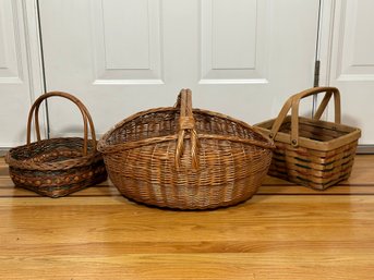 A Trio Of Woven Baskets With Top Handles