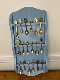 Collection Of Eighteen Souvenir Spoons On A Painted Spoon Rack