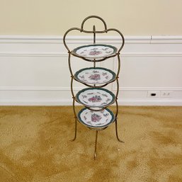 A Gold Tone Etagere With Floral Asian Plates