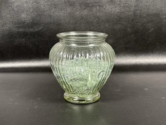 A Small Glass Vase With Ribbed Sides, Full Of Clear Glass Floral Beads