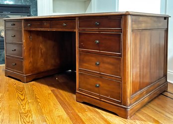 A Majestic Paneled Cherry Executive Desk With Tooled Leather Top