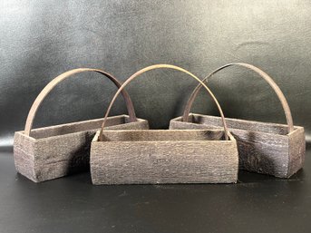 A Trio Of Rustic Wooden Baskets With Top Handles