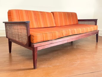 A Vintage Mid Century Modern Teak Sofa With Cane Sides