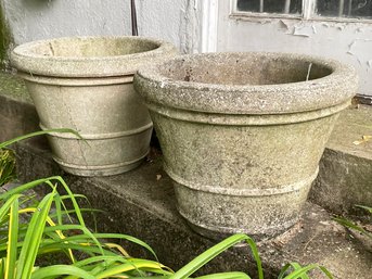 A Pair Of Cast Stone Planters