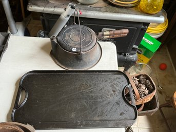 A CAST IRON WAGNER FLOP GRIDDLE AND A LODGE CAST IRON GRIDDLE