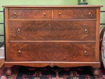 An Antique Dresser With Flame Mahogany Drawers