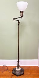 An Antique Bronze Standing Lamp With Milk Glass Under Shade
