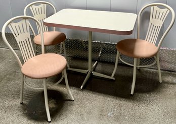 Pink And White Laminate Kitchen Table And Three Metal Chairs