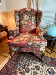 A CUSTOM UPHOLSTERED WING CHAIR WITH FLORAL FABRIC