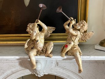 A PAIR OF DECORATIVE CHERUBS WITH HORNS