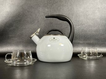 A Classic Chantal Teapot In Dove Gray With A Pair Of Modern Clear Glass Teacups & Saucers By Vahdam