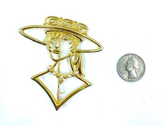 Gold Tone Silhouette Of Woman With Hat.