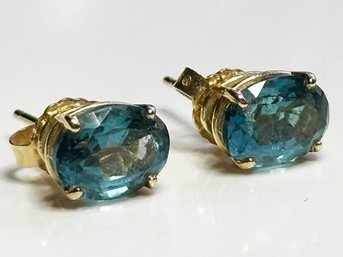 A Pair Of Blue Topaz Earrings In Gold Settings