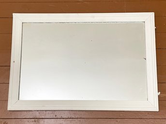 A Vintage Mirror In A White Painted Frame