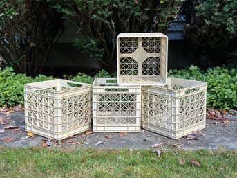 A Set Of Four Plastic Storage Crates In A Creamy White Tone