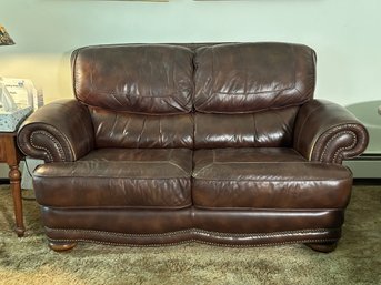 A Contemporary Love Seat In Brown Leather