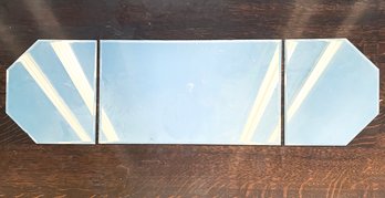 A Beveled Mirror In Three Sections