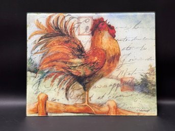 A Glass Cutting Board Featuring A Crowing Rooster