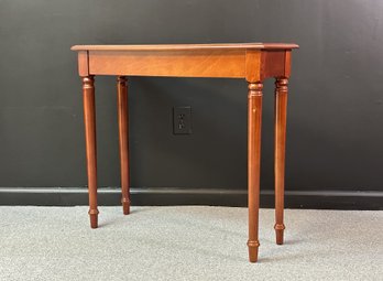 A Small Console Table In A Transitional Style