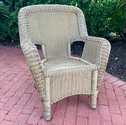 A Hampton Bay Faux Wicker Arm Chair