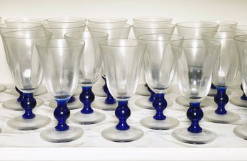 A Large Set Of Blue Stem Cocktail Glasses