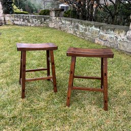 A Pair Of Wooden Saddle Stools
