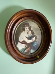 A PAIR OF ANTIQUE WALNUT OVAL FRAMES WITH PRINT