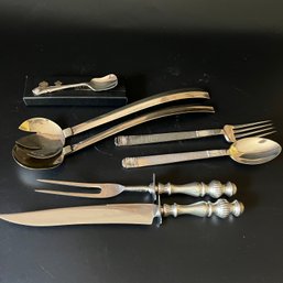 A Collection Of Serving Pieces And A Carving Set