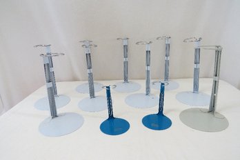 A Grouping Of Metal Doll Stands