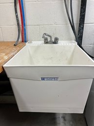 A Wall Mounted Utilitub Laundry Sink - Basement