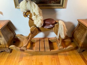 A PINE HOBBY HORSE WITH LEATHER SEAT