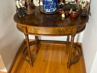 AN OVAL BURLWOOD INLAID CONSOLE TABLE