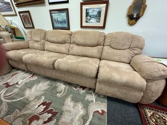 Long Four Cushion Sofa With Two Recliners On Ends And Two Round Storage Drums