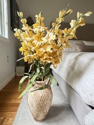 Beautiful Gladiolus Yellow Flowers In A Vase. Pottery Overlayed With Rattan Design