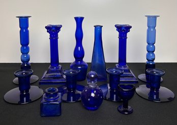 Assortment Of Blue Glass Candlestick Holders And Decour