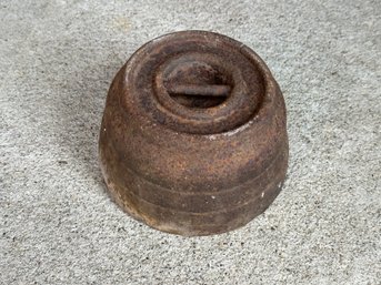 A Large Cast Iron Weight With An Aged Patina