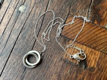 A Pair Of Vintage Tiffany & Co. Interlocking Sterling Silver Rings On A Dainty Chain