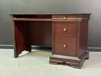 An Elegant Desk With Three Drawers & A Keyboard Tray By New Classics