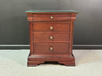 An Elegant Nightstand With Four Drawers & A Glass Top