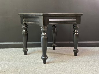 A Farmhouse Side Table With Turned Legs In Black