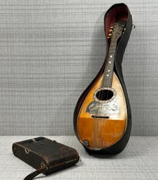 An Antique Mandolin And Camera