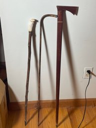 A STERLING SILVER MOUNTED WALKING STICK, A STAG HANDLE WALKING STICK, AND TWO OTHER WALKING STICKS